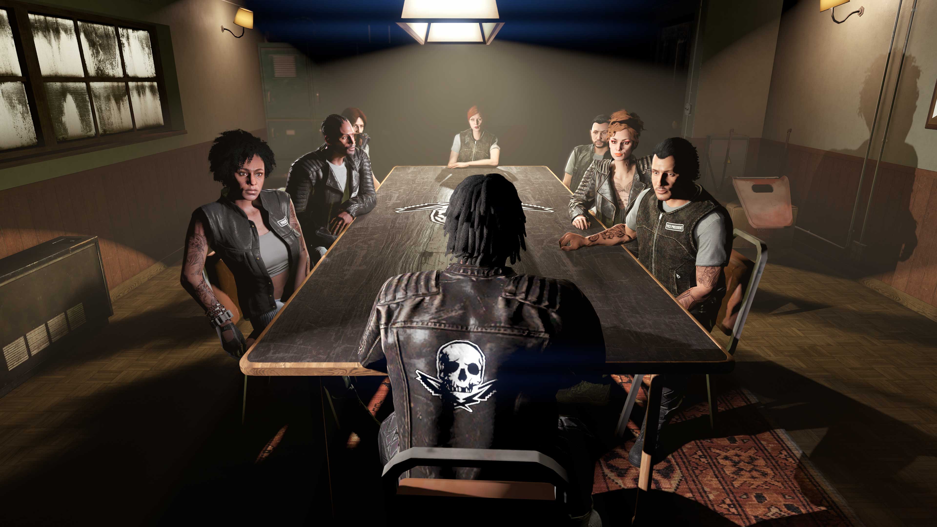 Bikers in their safehouse sit around a long table having a meeting. 