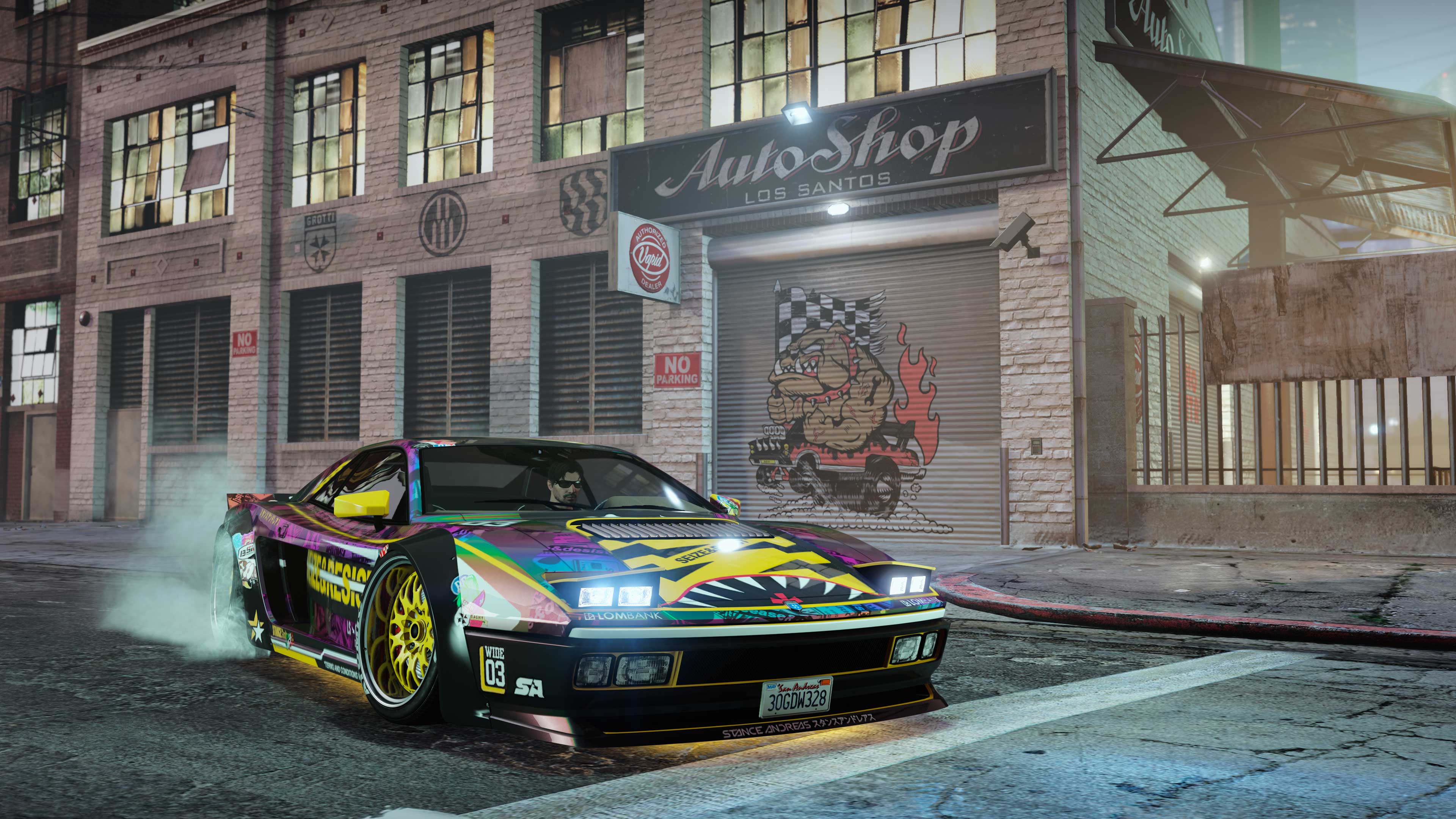 A modified car parked outside an auto shop property. 