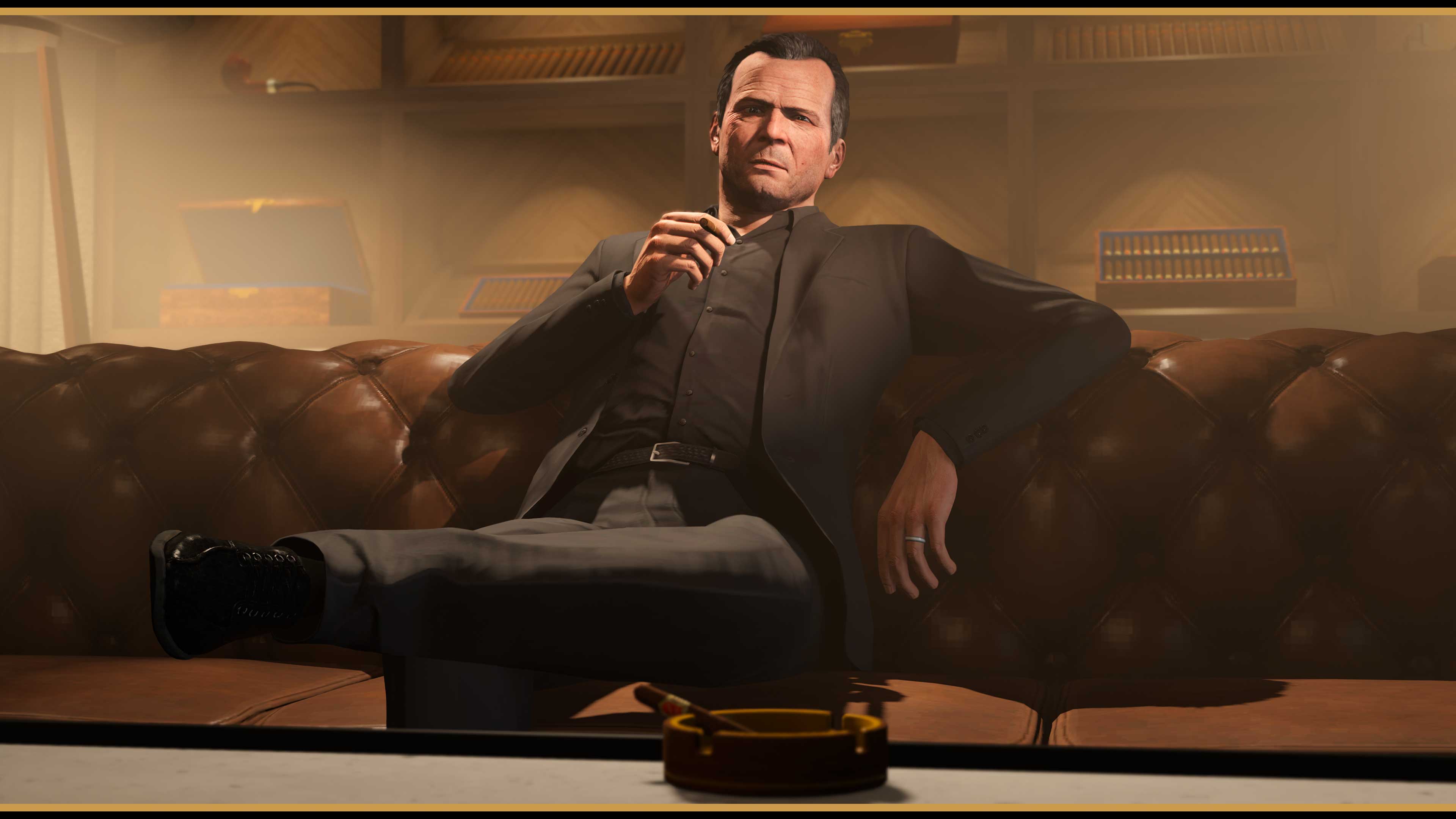 Michael leans back into a leather sofa smoking a cigar in the Cigar Room. 