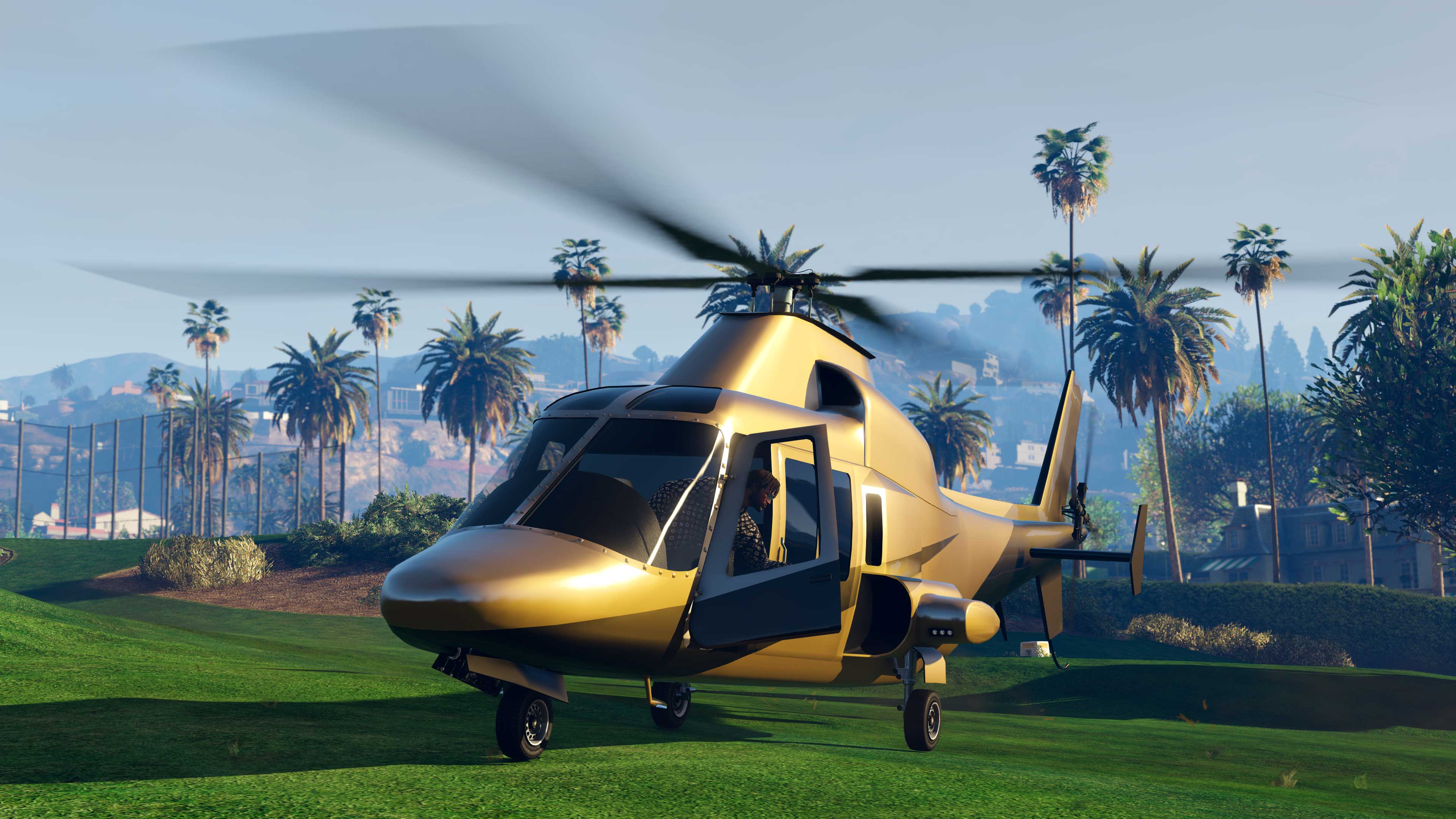 A Buckingham Swift Deluxe helicopter in the middle of a golf green. 