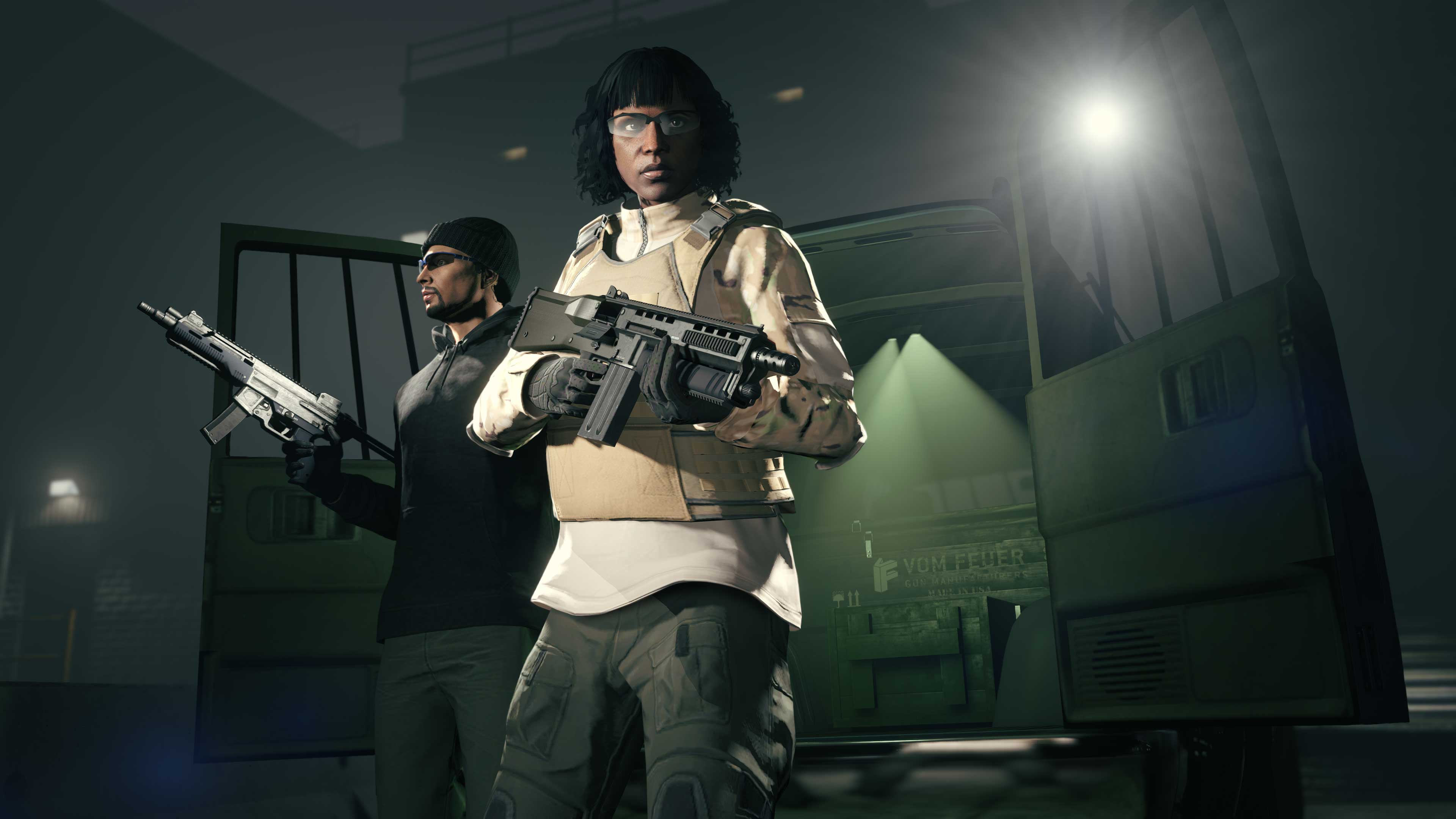 Two armed characters stand at the rear of the Gun Van with its doors open. 
