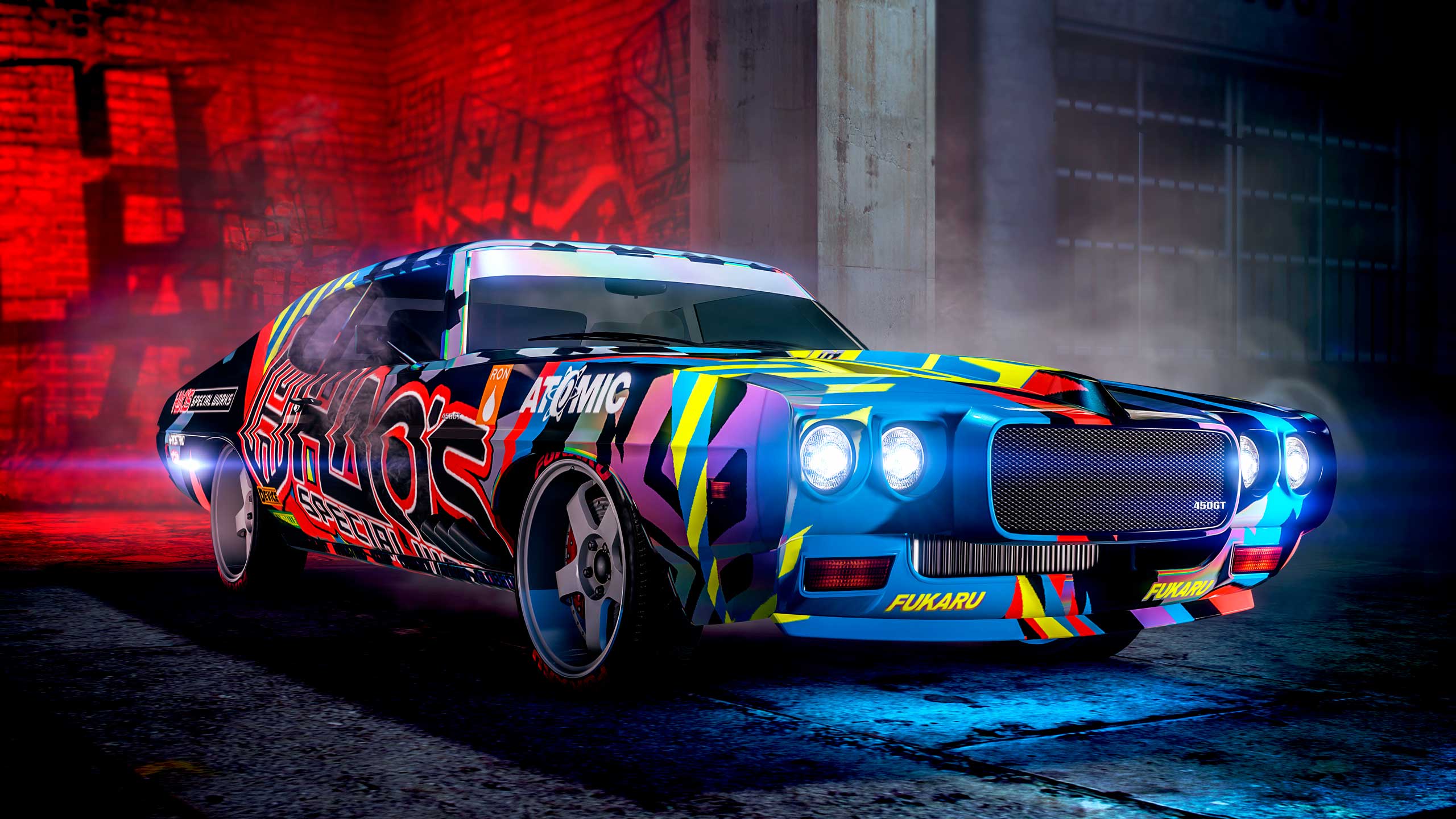 A car with an abstract, multicolored livery parked in a dark warehouse. 
