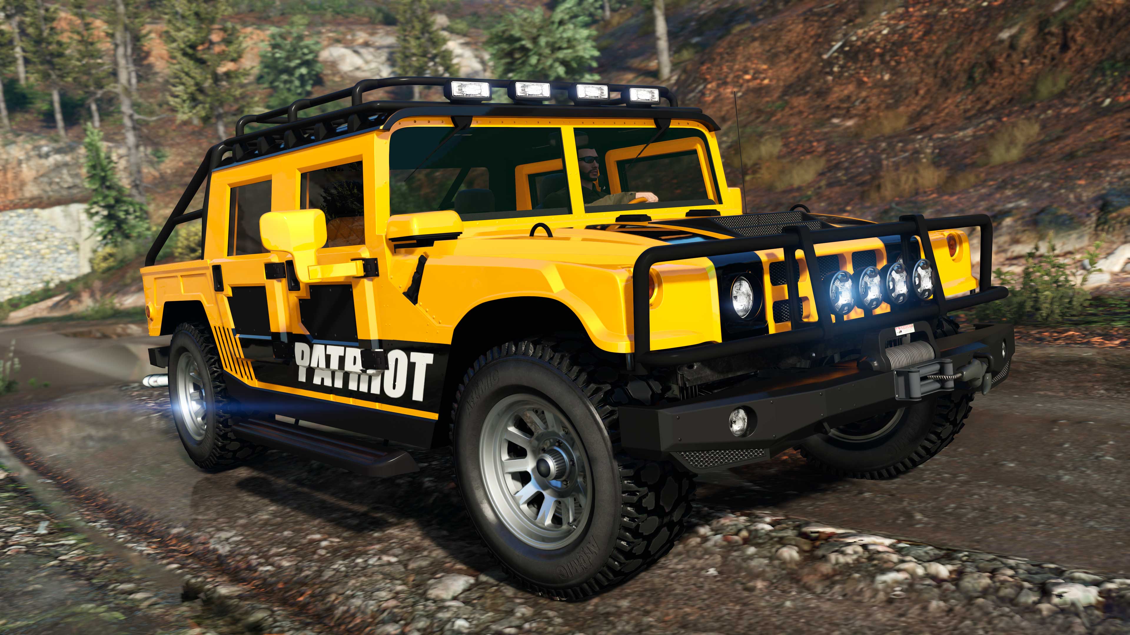 A yellow Mammoth Patriot Mil-Spec driving on an off-road route. 