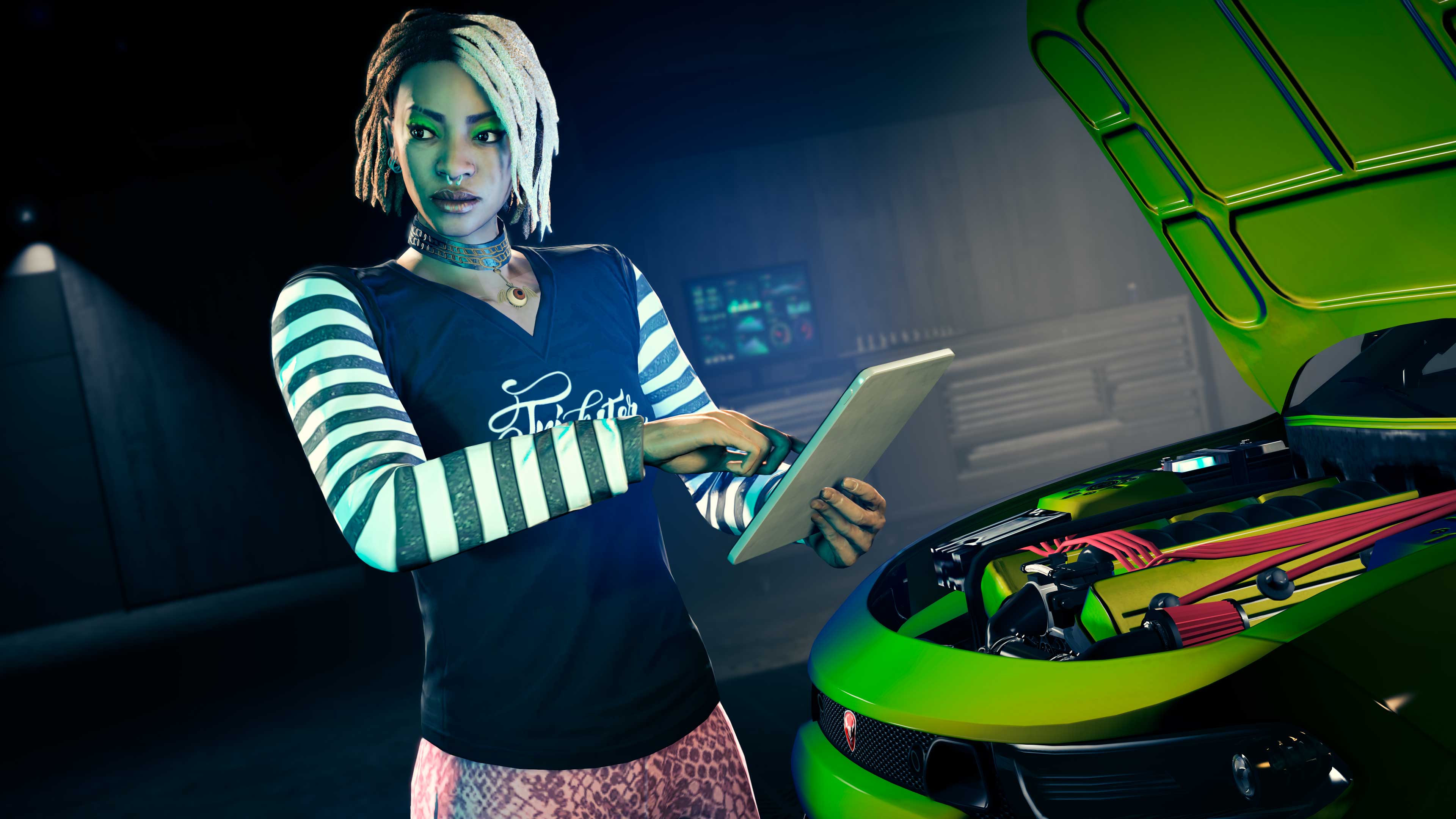 Imani reads from a digital tablet in front of a modified car with its hood opened. 