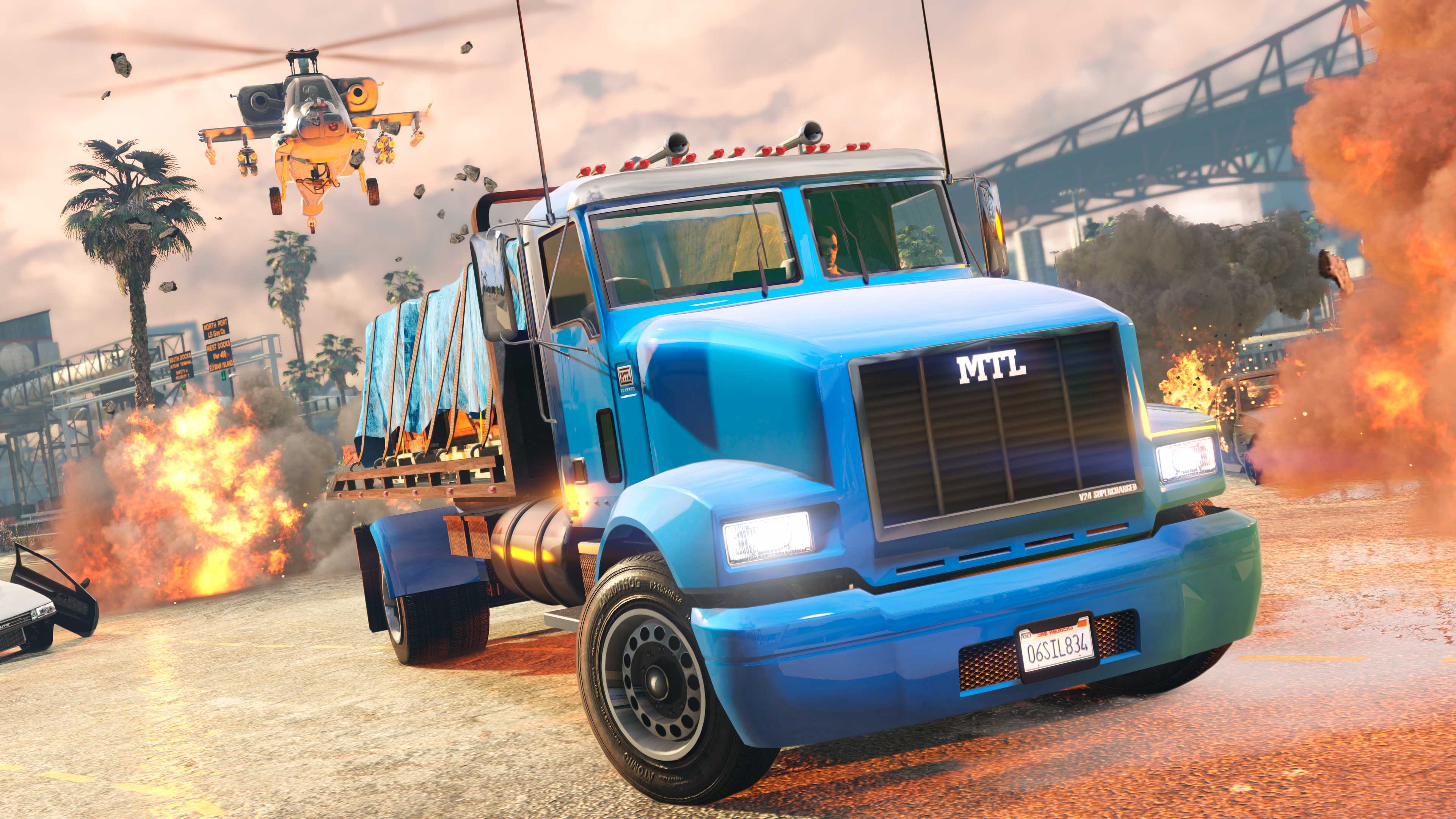 A truck carrying cargo drives away from explosions as a helicopter is in pursuit.