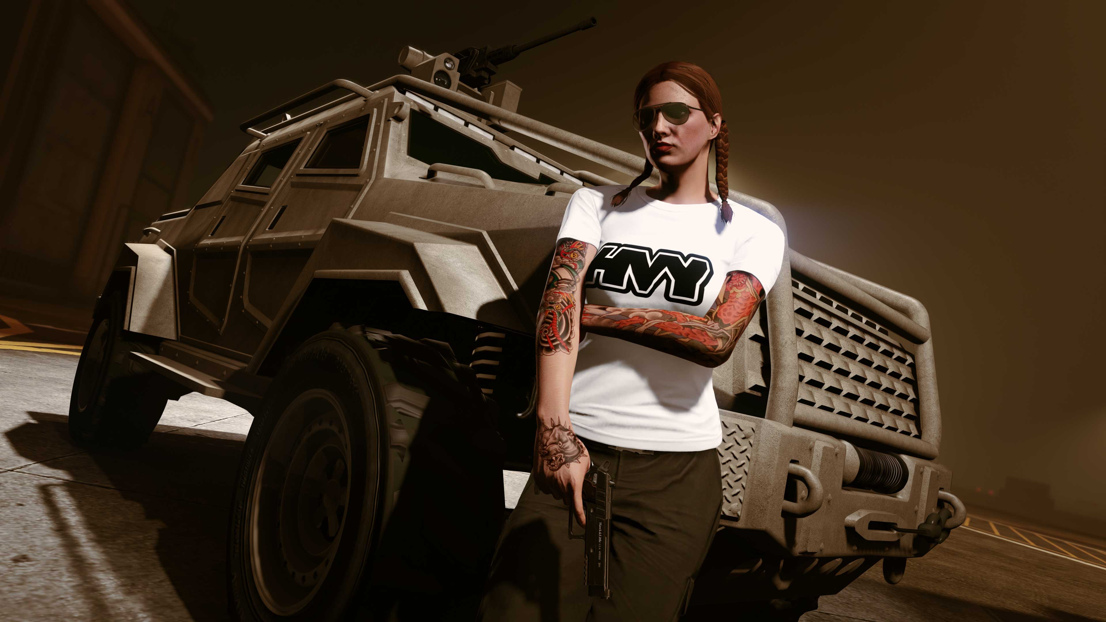 A GTA Online player stands in front of an HVY Insurgent Pick-Up wearing a white HVY Tee.
