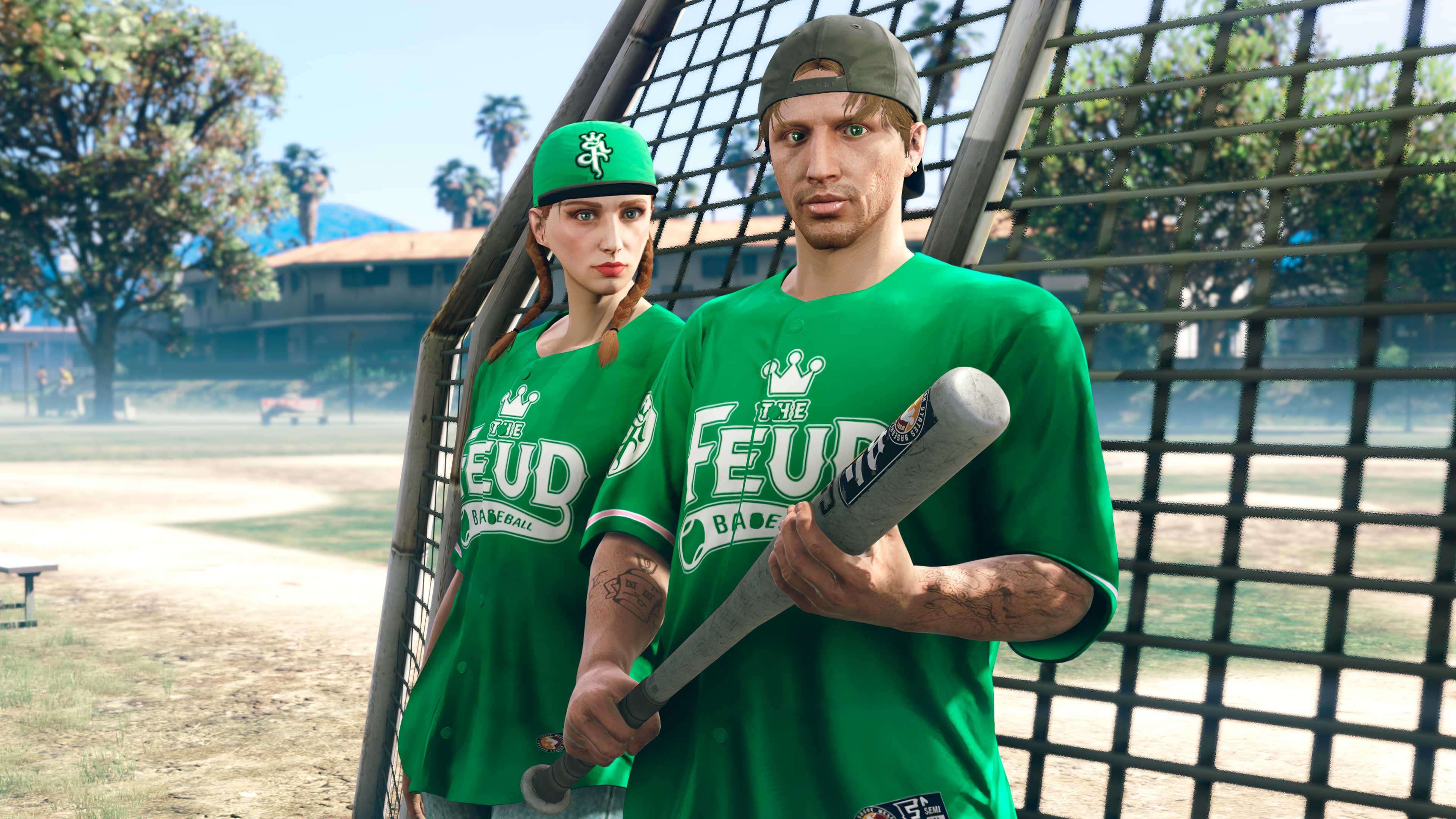 Two GTA Online characters wearing the Feud Baseball Jersey as they stand near a baseball pitch. 