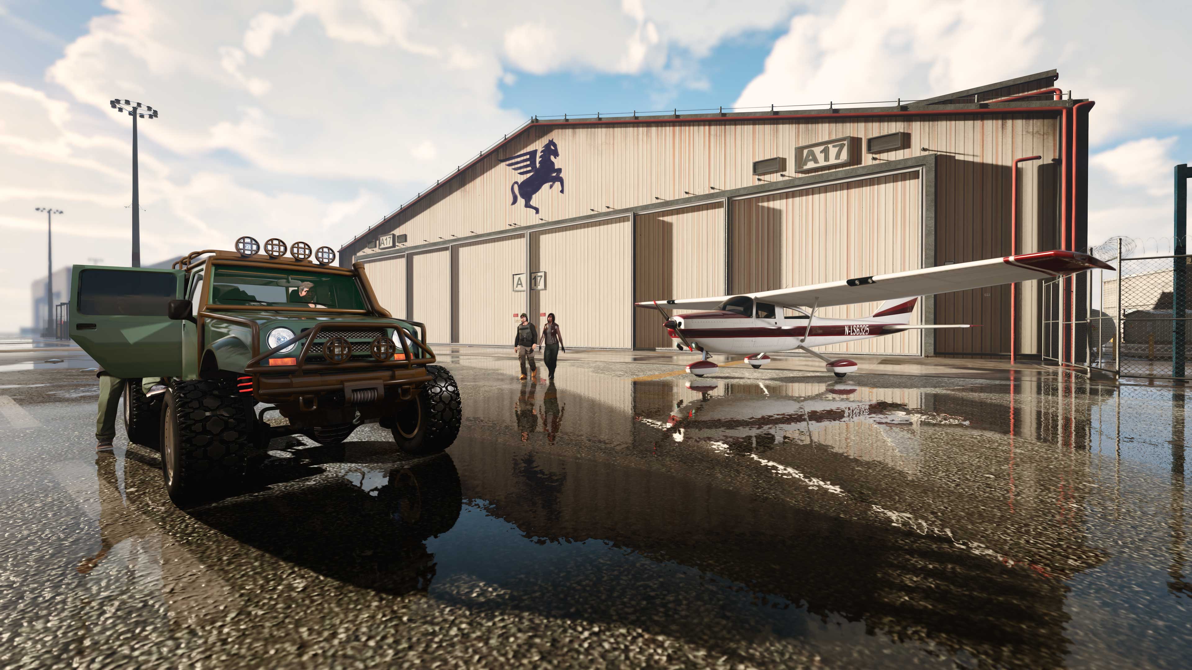 A Hangar property with a plane and an off-road vehicle outside. 